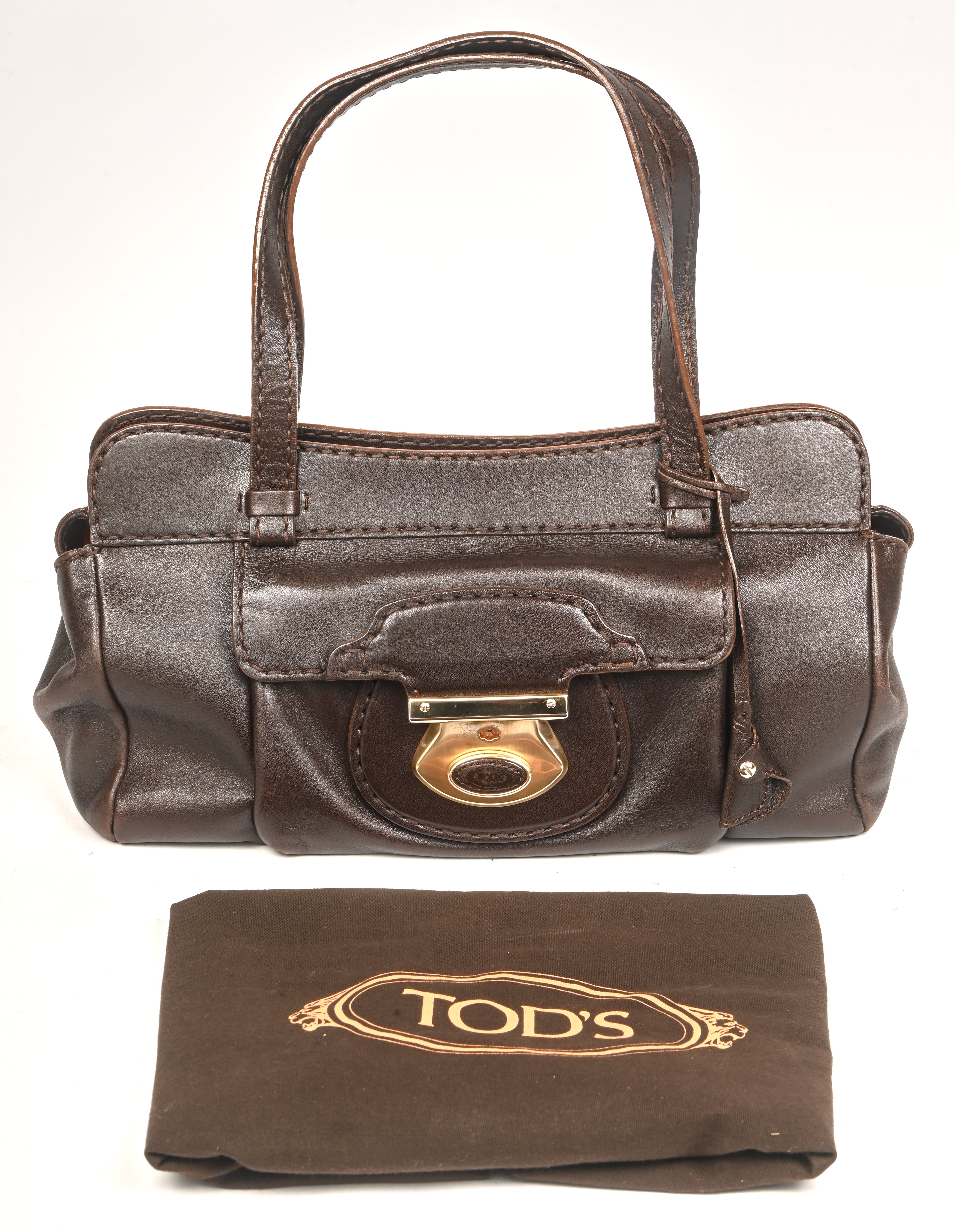 Een Tod’s handtas ‘Happy Patina Grande’ in bruin leer. Met sleutel. Met originele zak Een Tod’s handtas ‘Happy Patina Grande’ in bruin leer. Met sleutel. Met originele zak.