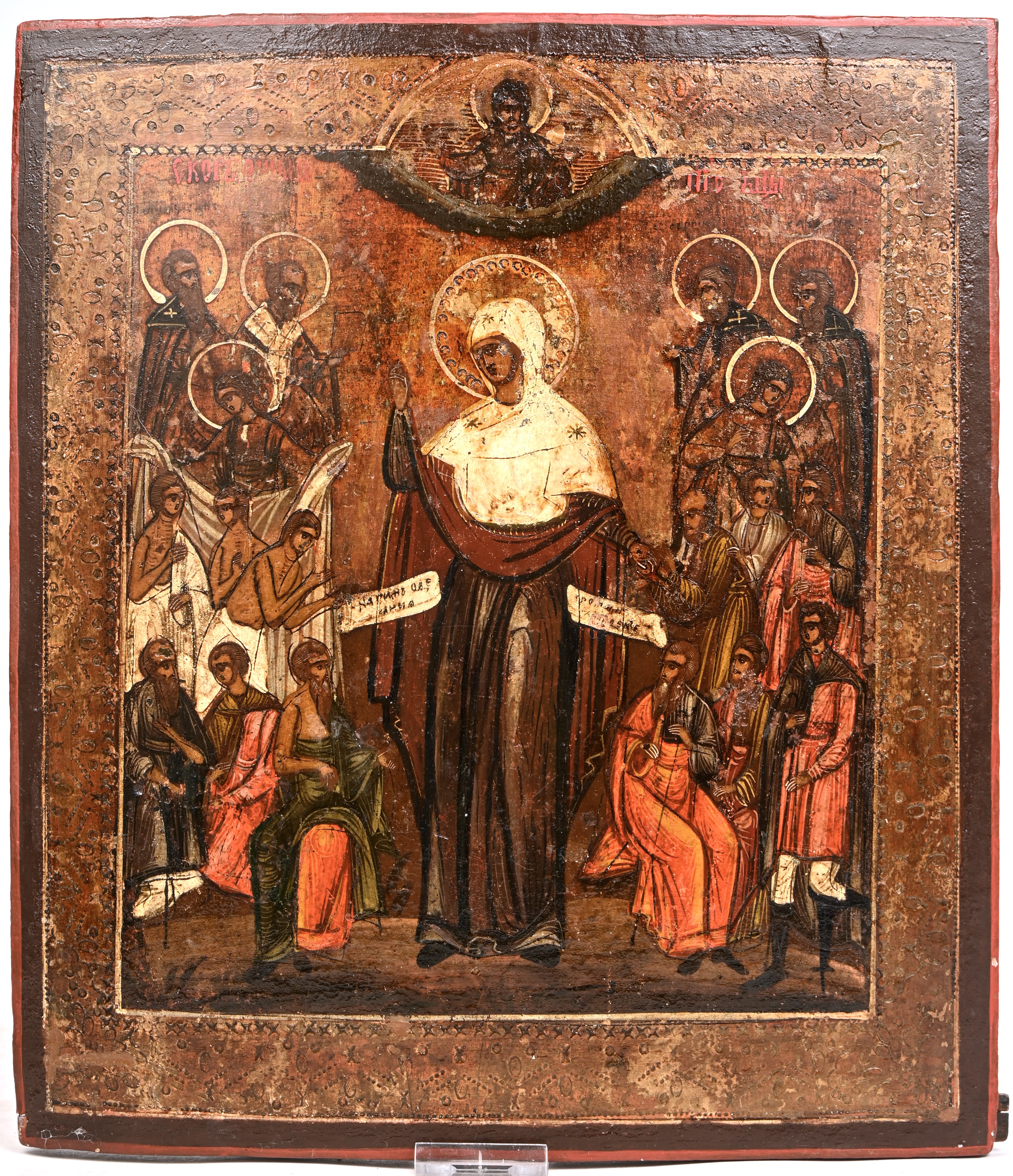 “De Moeder Gods met talrijke Heiligen en Martelaren”. Russische icoon. Tempera en zilververf op paneel, XIXde eeuw “De Moeder Gods met talrijke Heiligen en Martelaren”. Russische icoon. Tempera en zilververf op paneel, XIXde eeuw.