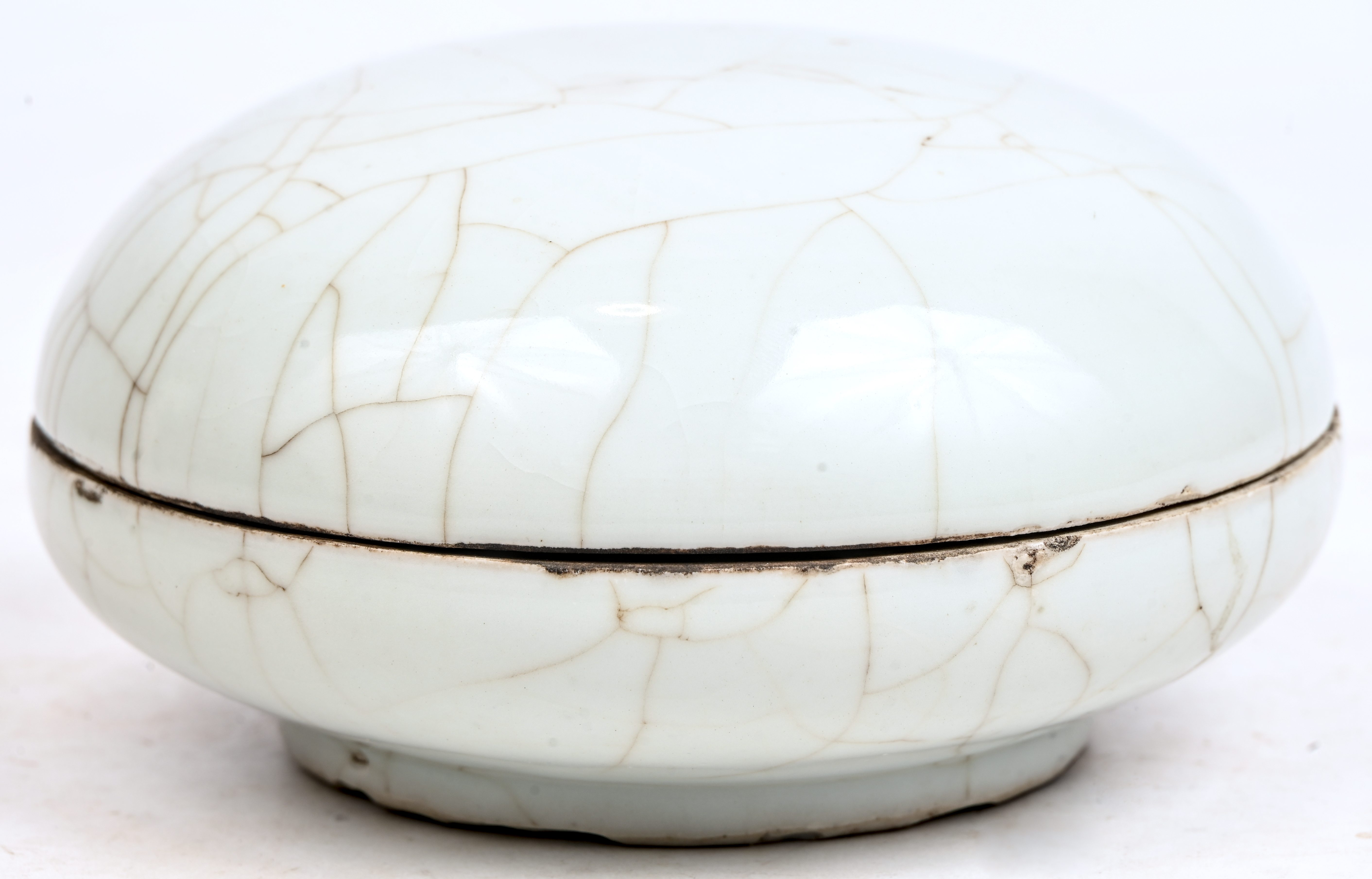 Een gecraqueleerde schaal met deksel in Celadon porselein. Schilfers van de voet Een gecraqueleerde schaal met deksel in Celadon porselein. Schilfers van de voet.