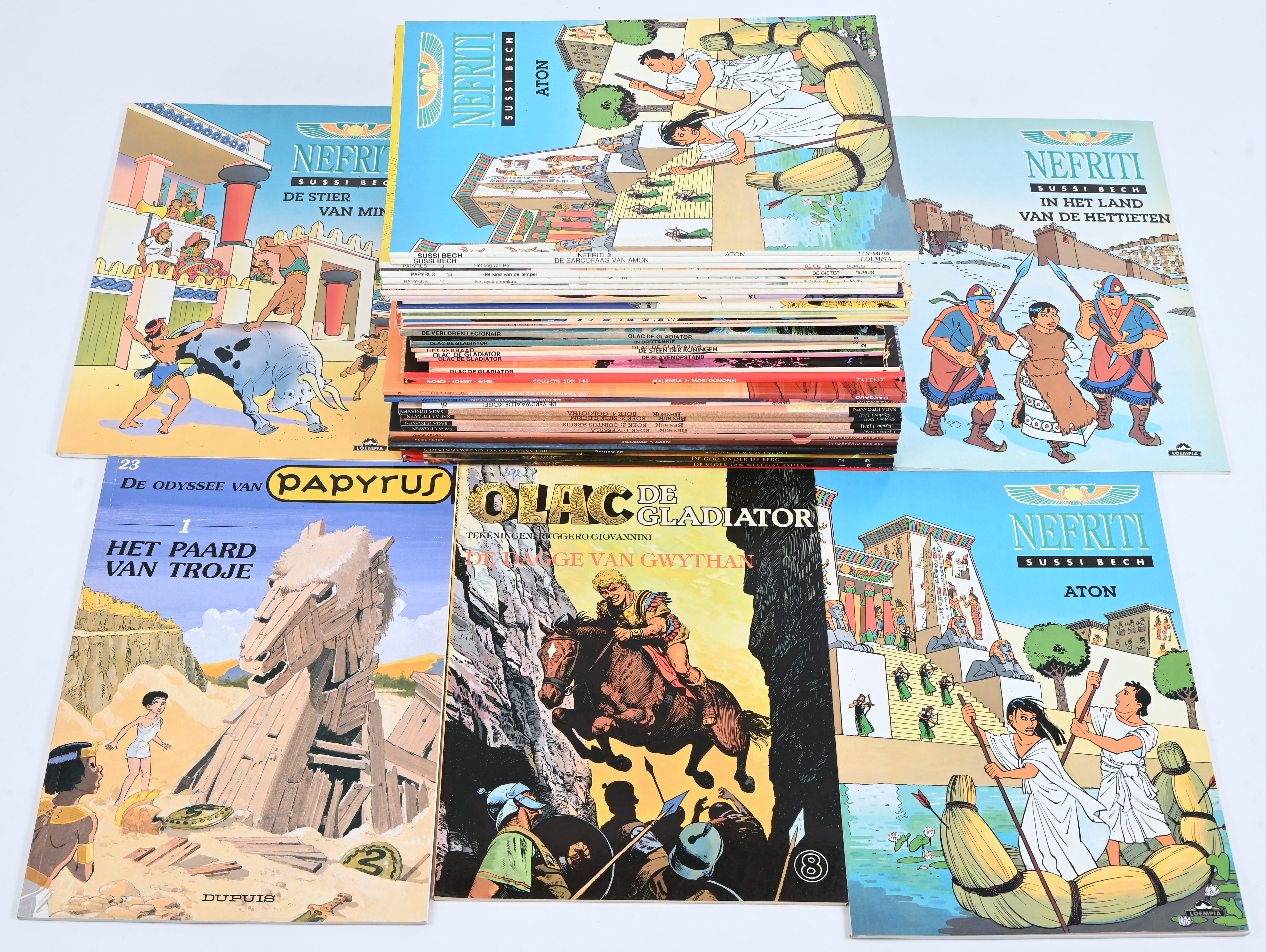 Een partij stripalbums met titels uit de reeksen: ‘Troll’ (2), ‘Ravine’ (3), ‘De Balling’ (1), ‘Belladonna’ (2), ‘Ben Hur’ (4), ‘Buddy Longway’ (2), ‘Mayam’ (2), ‘Malienda’ (1), ‘Olac de Gladiator’ (8), ‘Papyrus’ (13) en ‘Nefriti’ (5). Mogelijk met geschreven markeringen op de kaft Een partij stripalbums met titels uit de reeksen: ‘Troll’ (2), ‘Ravine’ (3), ‘De Balling’ (1), ‘Belladonna’ (2), ‘Ben Hur’ (4), ‘Buddy Longway’ (2), ‘Mayam’ (2), ‘Malienda’ (1), ‘Olac de Gladiator’ (8), ‘Papyrus’ (13) en ‘Nefriti’ (5). Mogelijk met geschreven markeringen op de kaft.