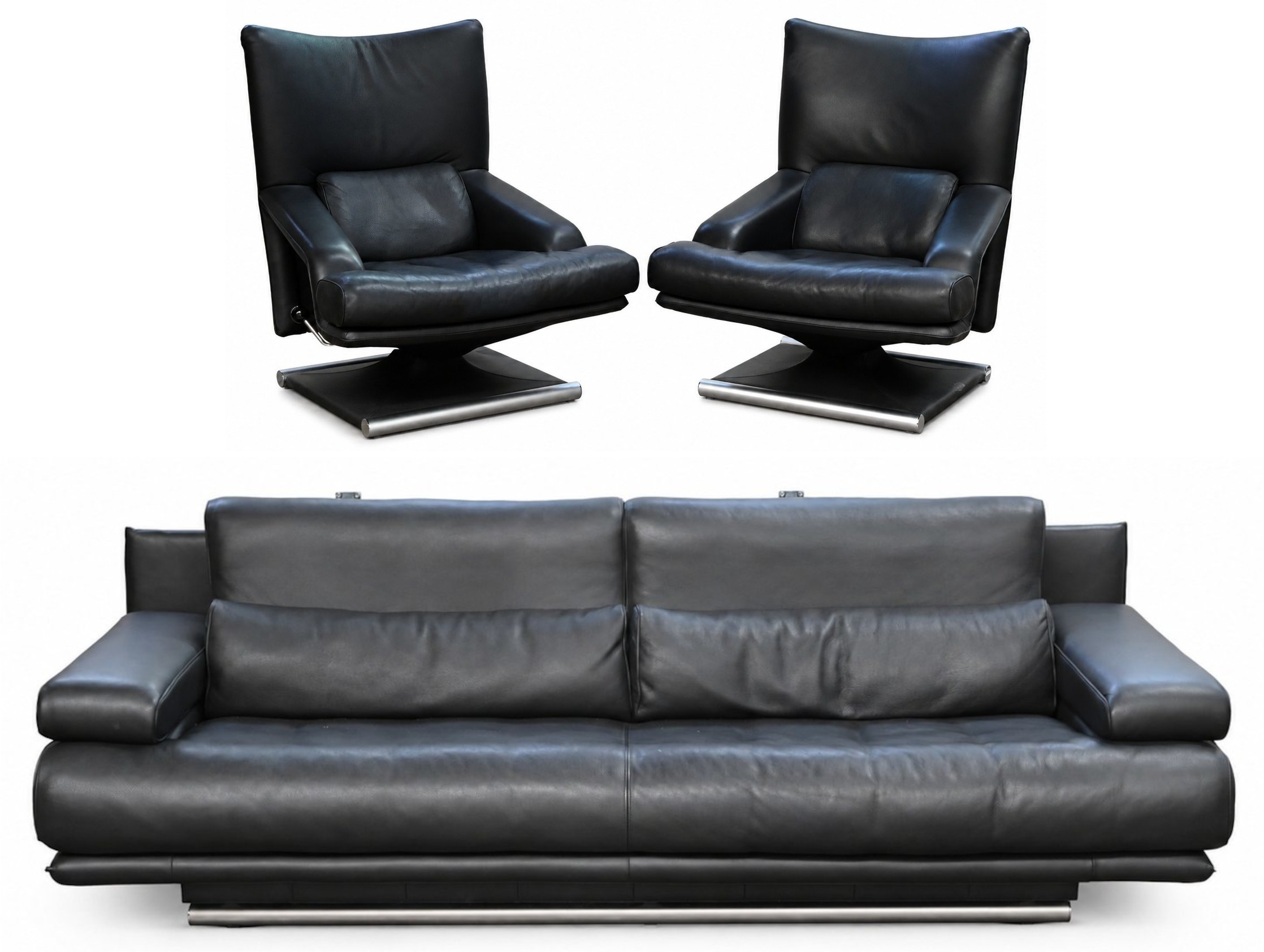 Een zwart lederen design salon bestaande uit 2 manuele relax-fauteauils en een driezit Een zwart lederen design salon bestaande uit 2 manuele relax-fauteauils en een driezit.