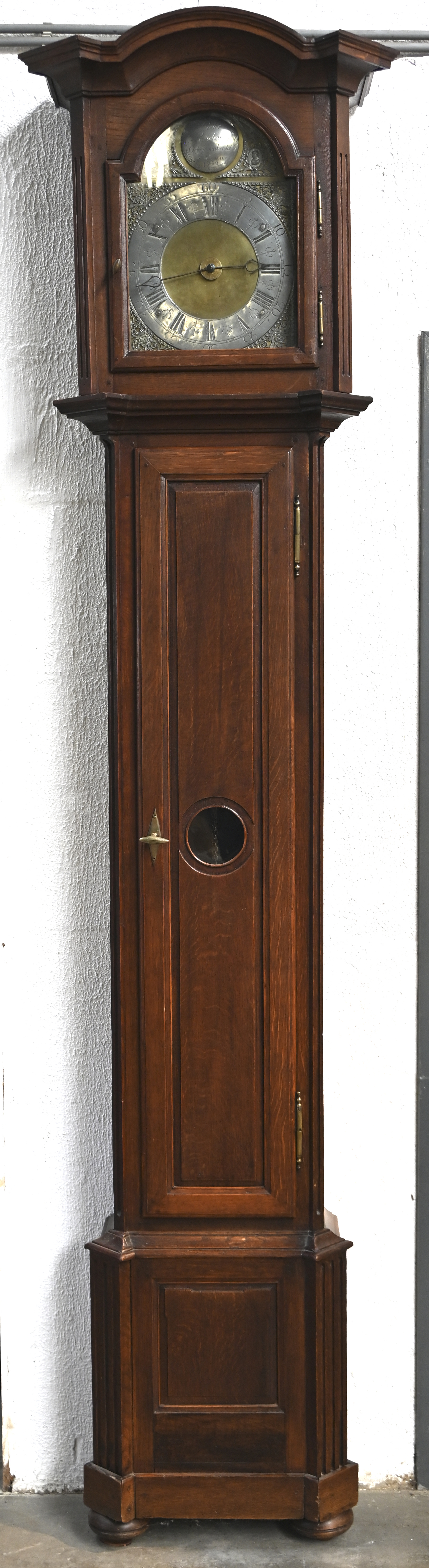 Een staande klok in eikenhouten kast, met opschrift Pieter Rombaut, Orlogemaker tot Ste Nicolaes 1752. Kast uit de XIXde eeuw. Met slinger en gewichten Een staande klok in eikenhouten kast, met opschrift Pieter Rombaut, Orlogemaker tot Ste Nicolaes 1752. Kast uit de XIXde eeuw. Met slinger en gewichten.